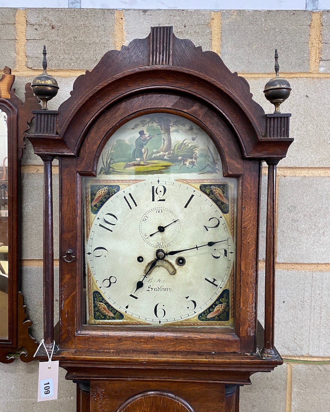 An early 19th century oak cased 8 day longcase clock, the arched painted dial marked Sudbury, height 212cm